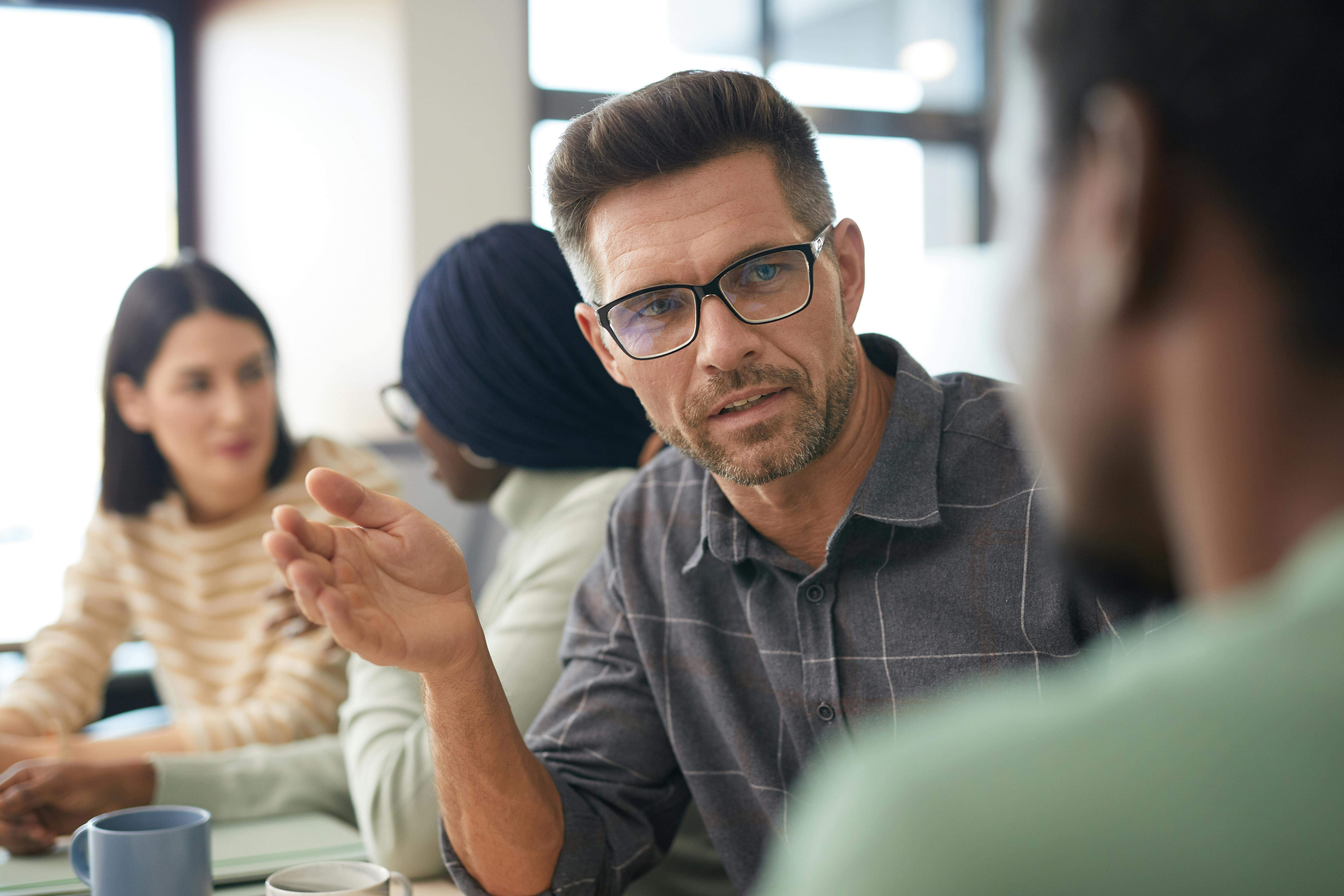 A Group of People Having a Meeting in the Office