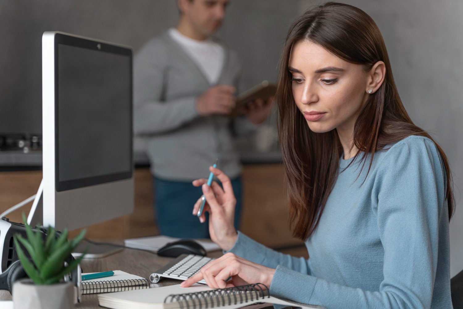 Side view of woman working in the media field with personal computer.