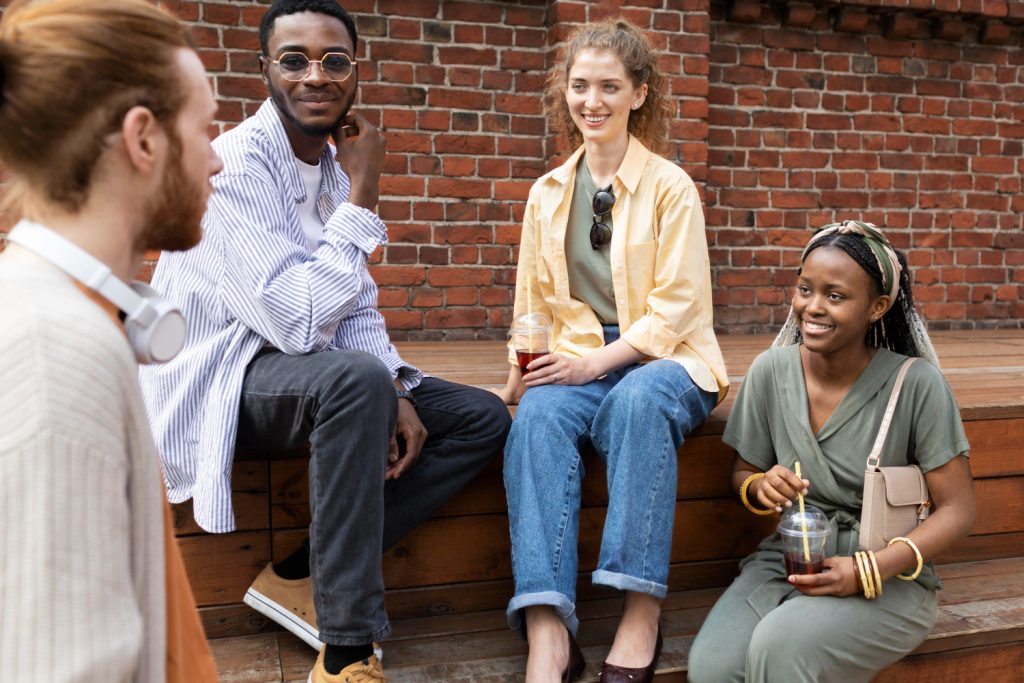 Close up friends sitting outdoors.