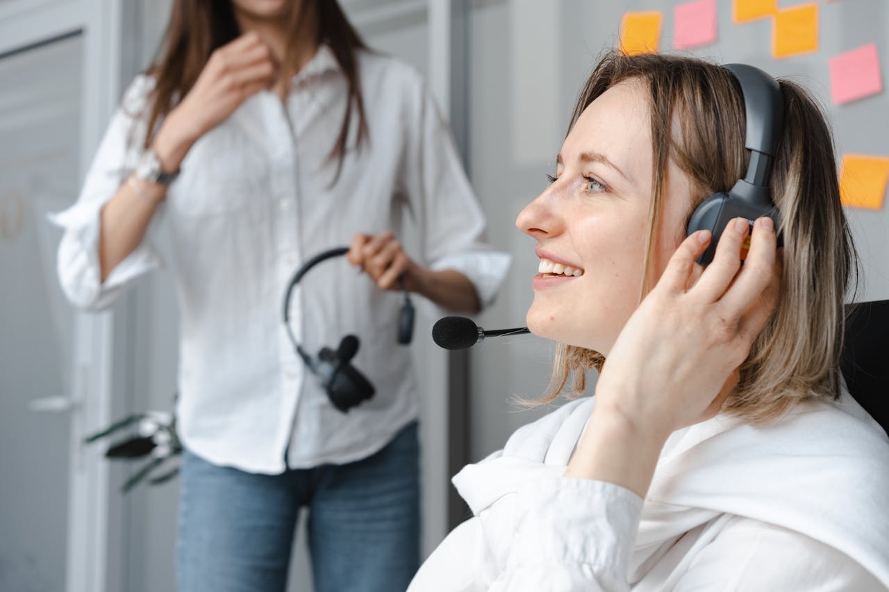 Close-Up Photo of Smiling Woman Wearing Headphones.