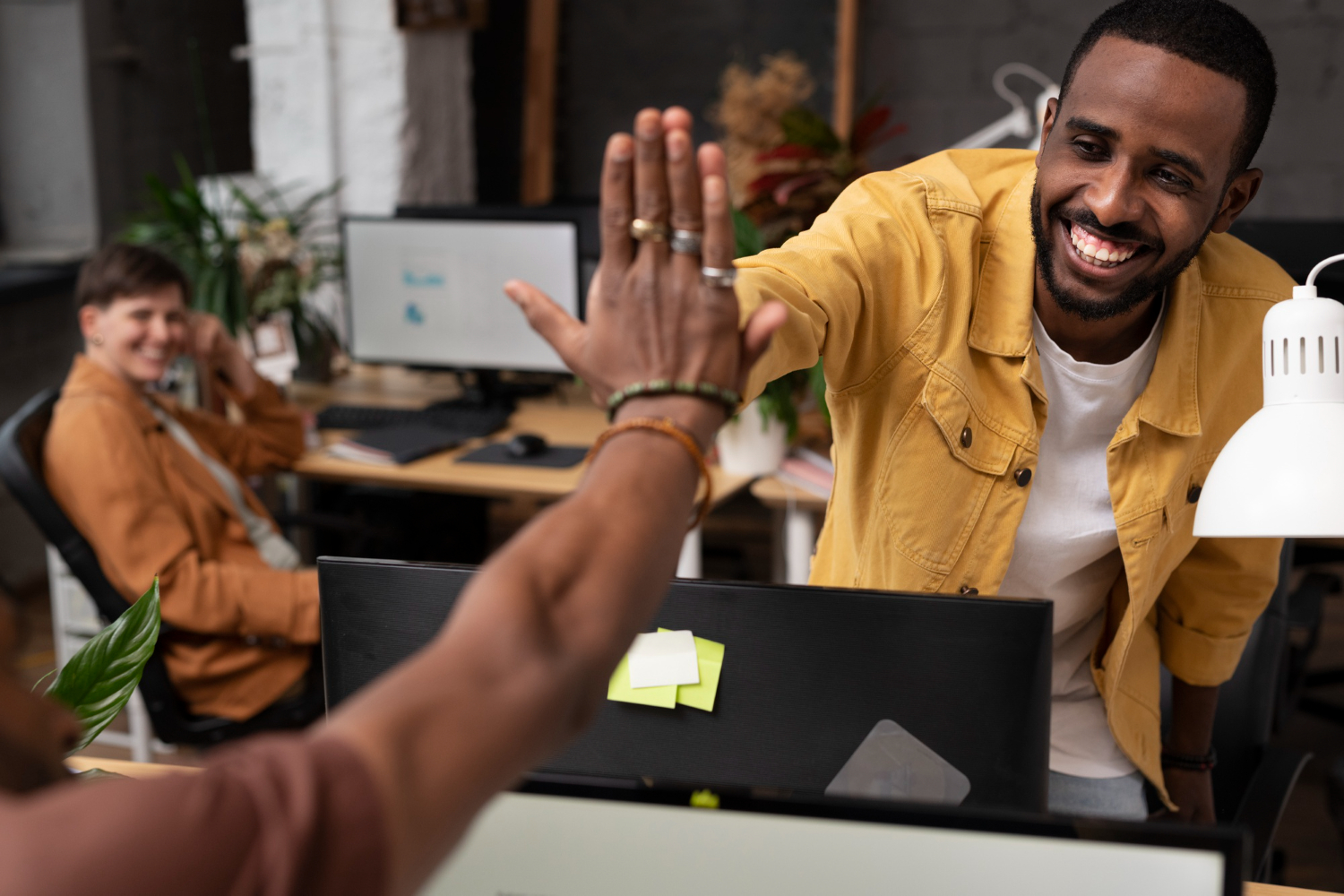 Close up colleagues high five.