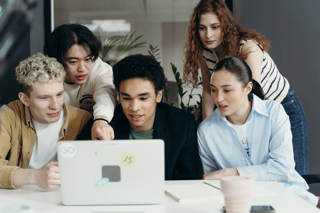 People Looking at a Laptop