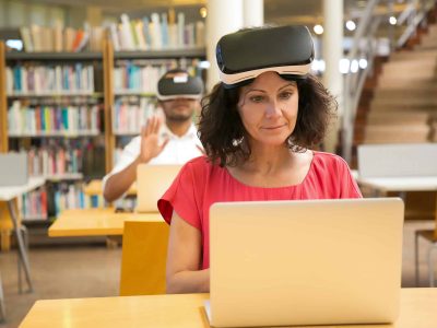 Front view of cheerful Caucasian woman setting VR headset.