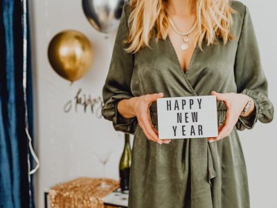 Woman Holding White Card With Happy New Year Text