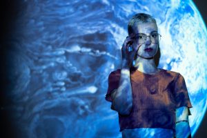 Portrait of young woman with universe projection texture