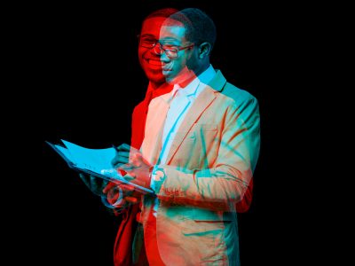 Businessman with notebook in double color exposure effect.