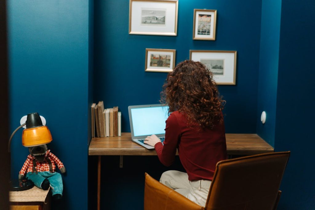 A Person In Front Of A Laptop.