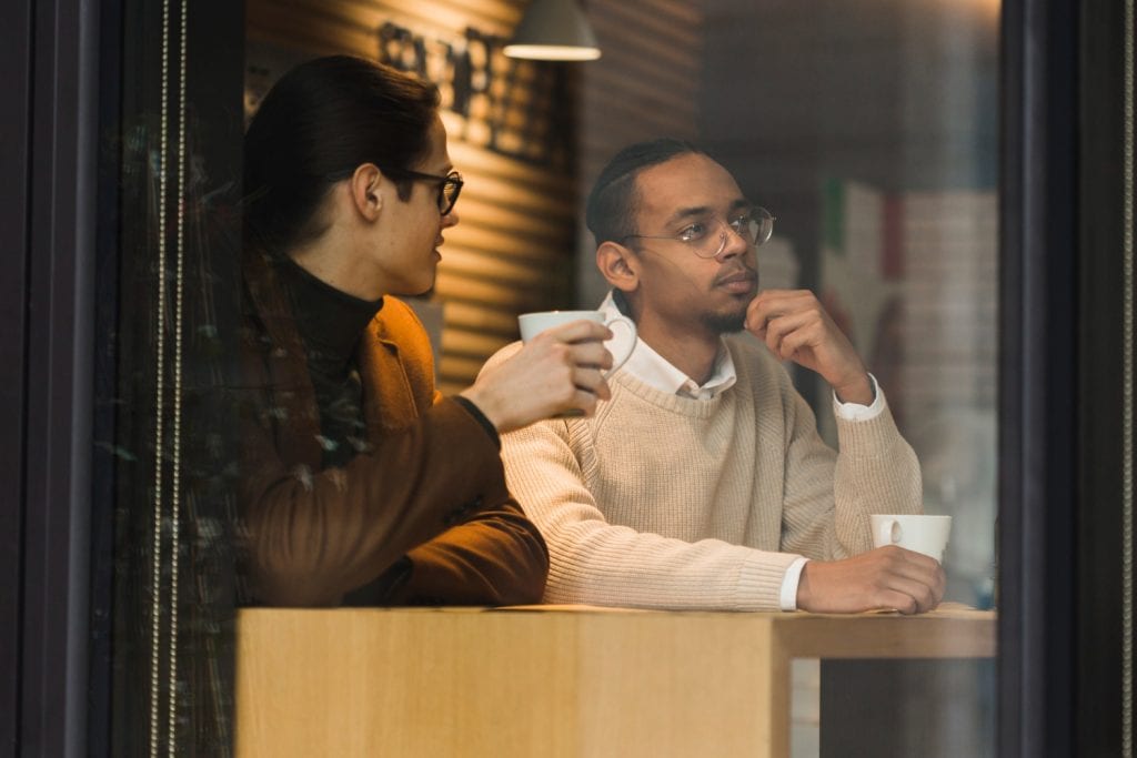 Medium shot guys with mugs thinking.